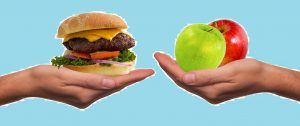 een hand met een cheeseburger tegenover een hand met 2 appels